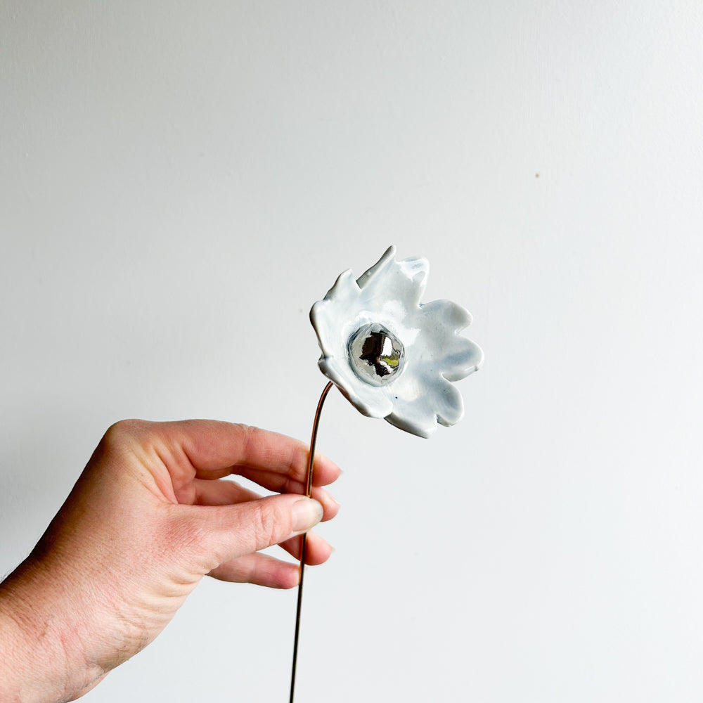 Large porcelain flower on brass