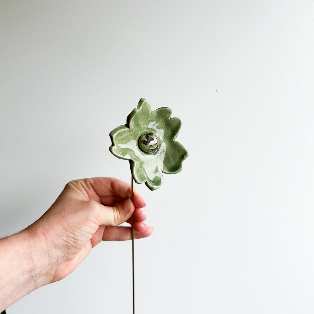 Large porcelain flower on brass