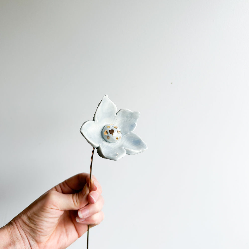 Large porcelain flower on brass