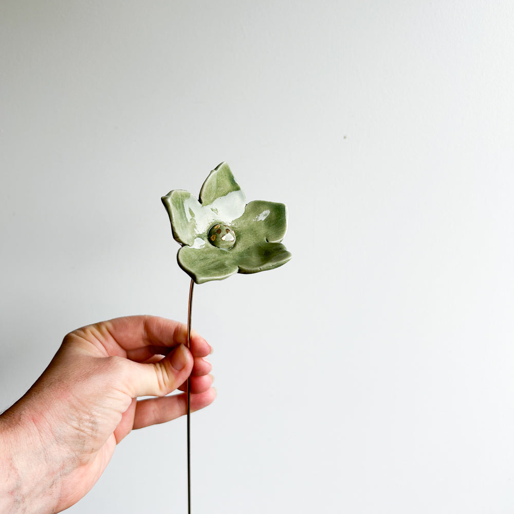 Large porcelain flower on brass