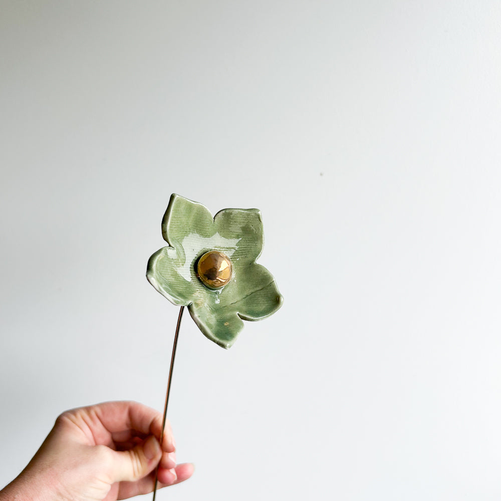 Large porcelain flower on brass