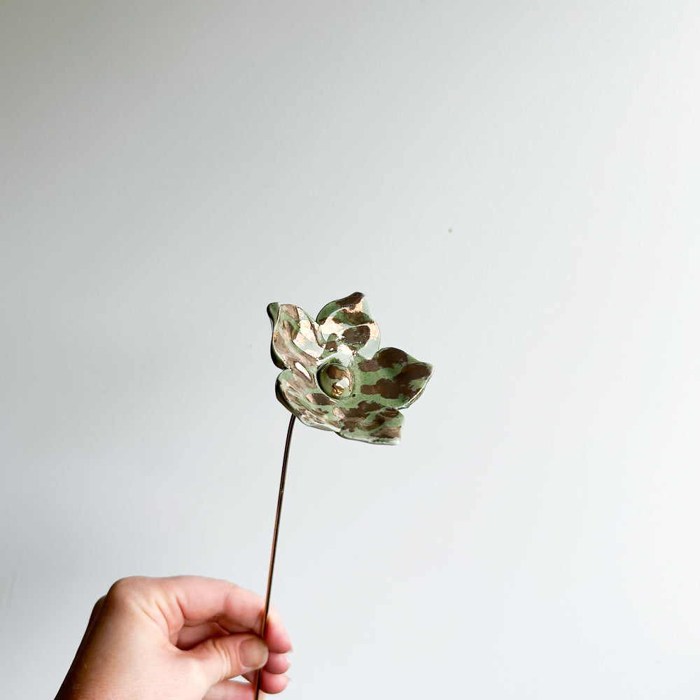 Large porcelain flower on brass