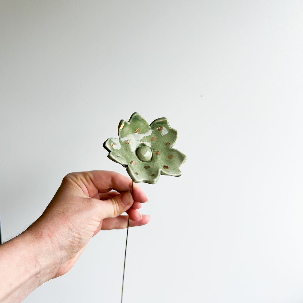 Large porcelain flower on brass