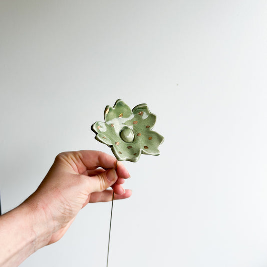 Large porcelain flower on brass